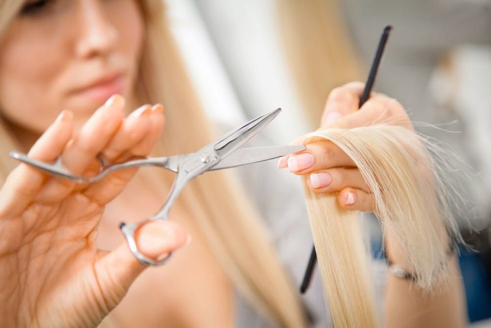 Woman cutting hair. 