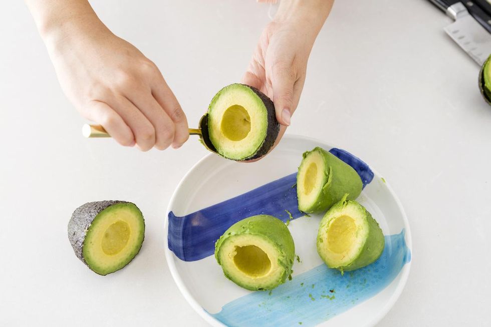 woman cutting up an avocado
