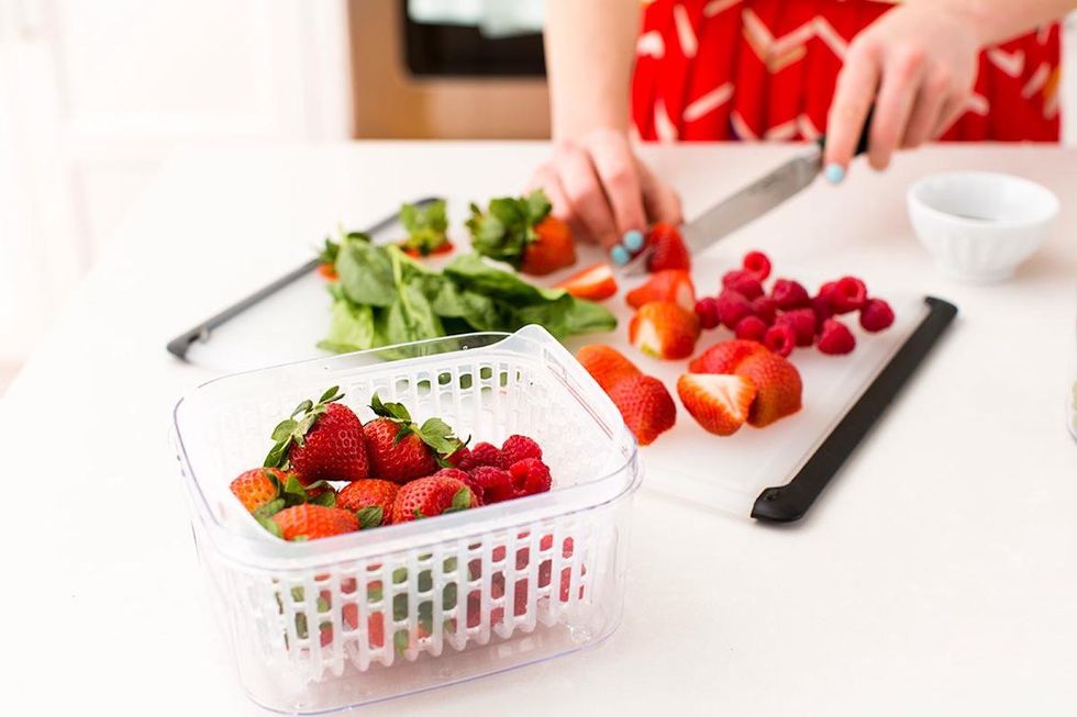 woman cutting up strawberries dehydration