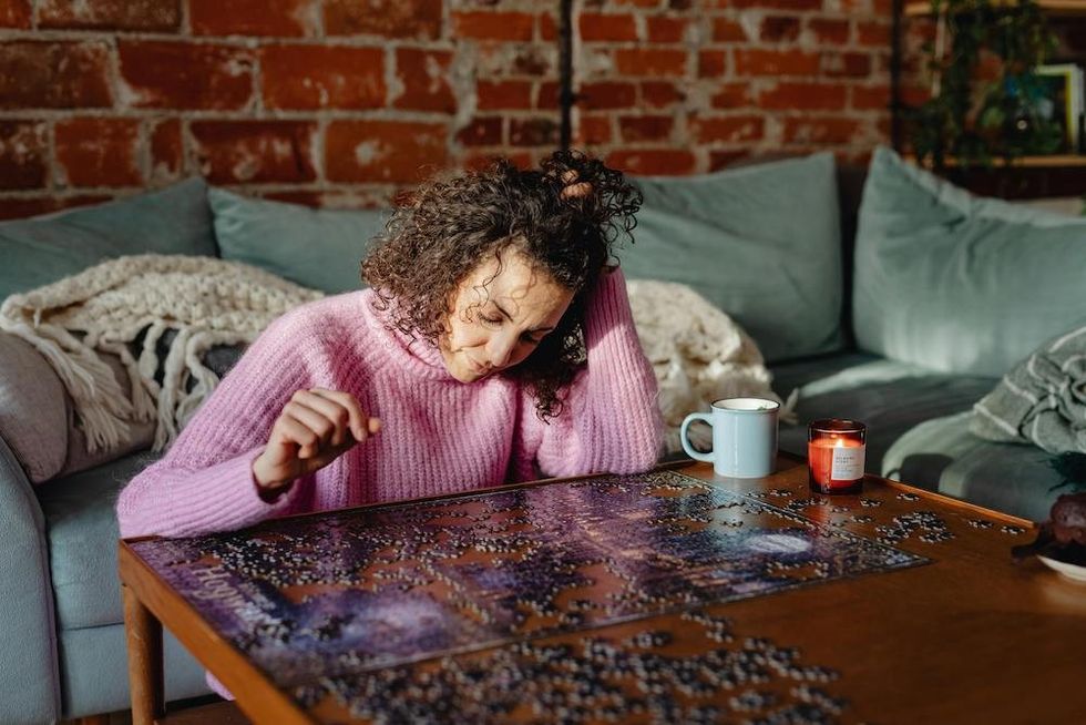 woman doing a jigsaw puzzle