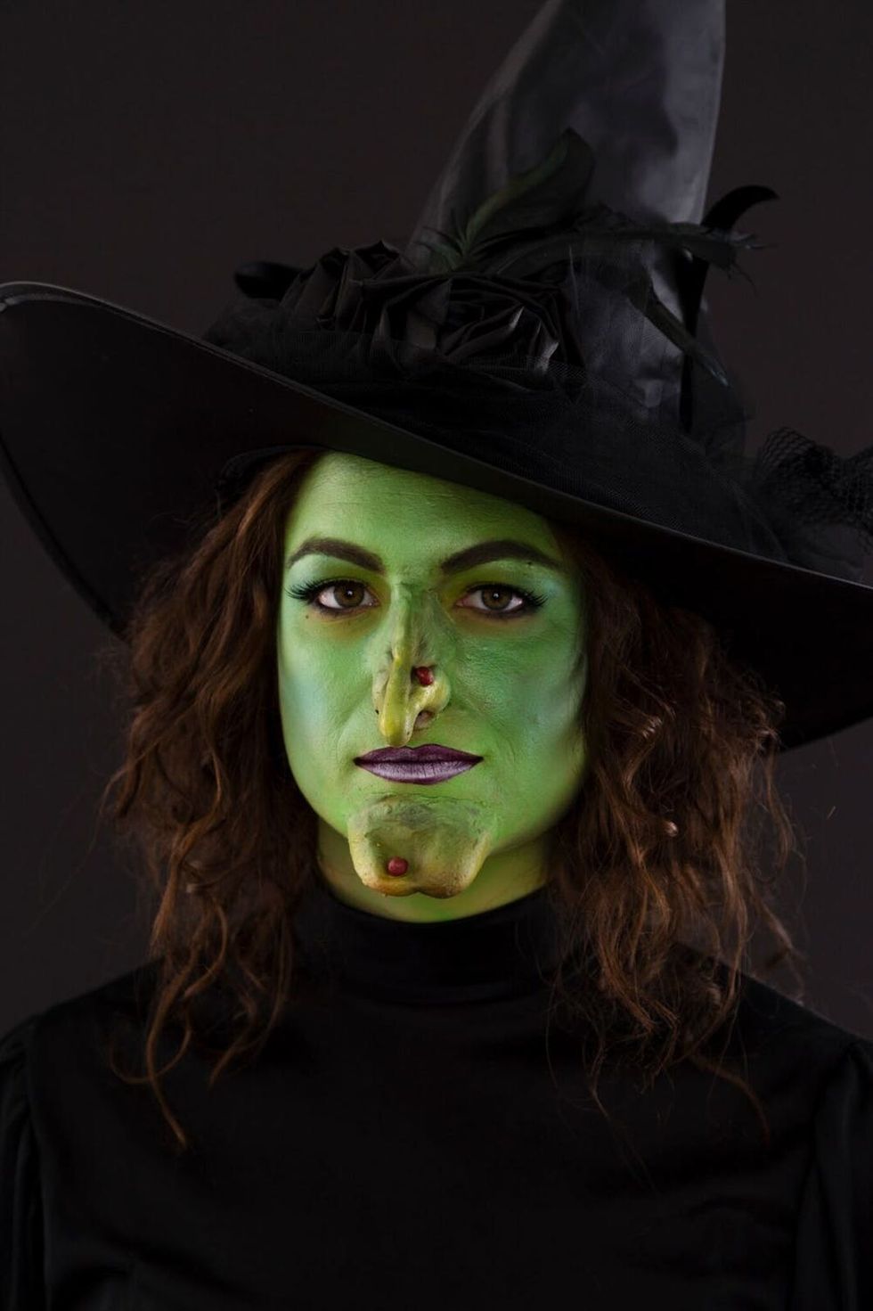 Woman dressed as the Wicked Witch of the West for Halloween.