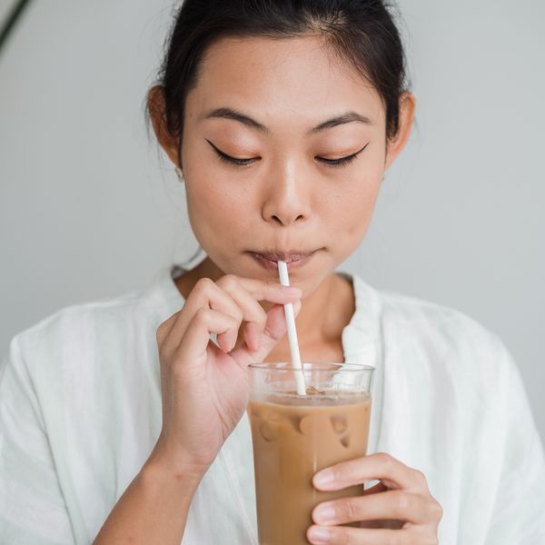 woman drinking an iced coffee dunkin spiked