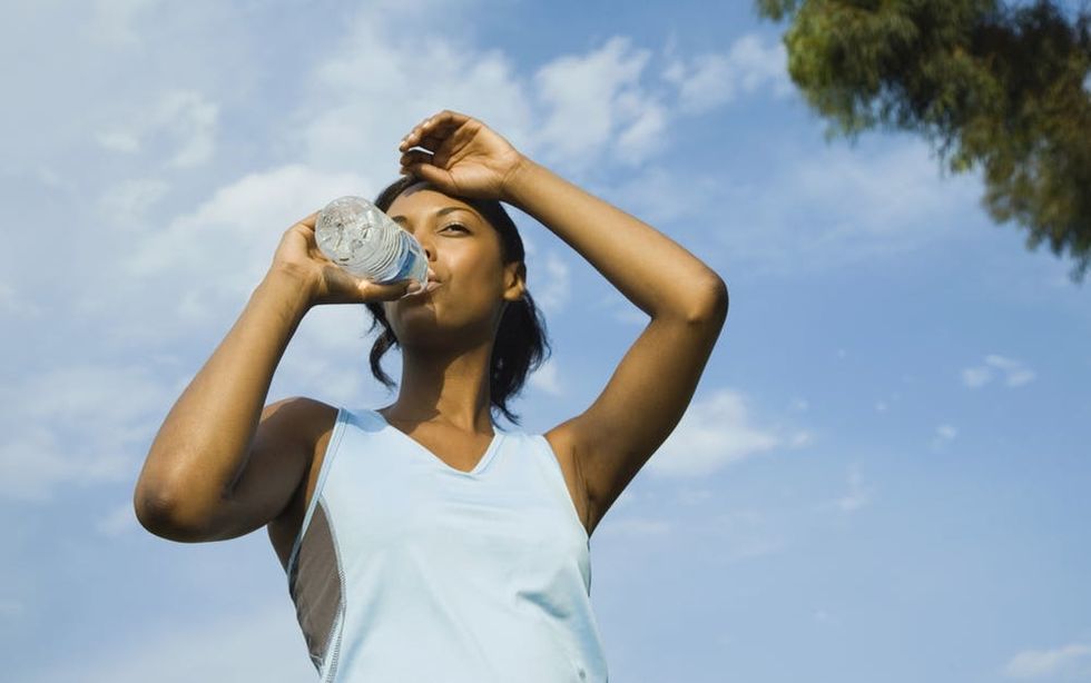 Woman drinking water in the summer