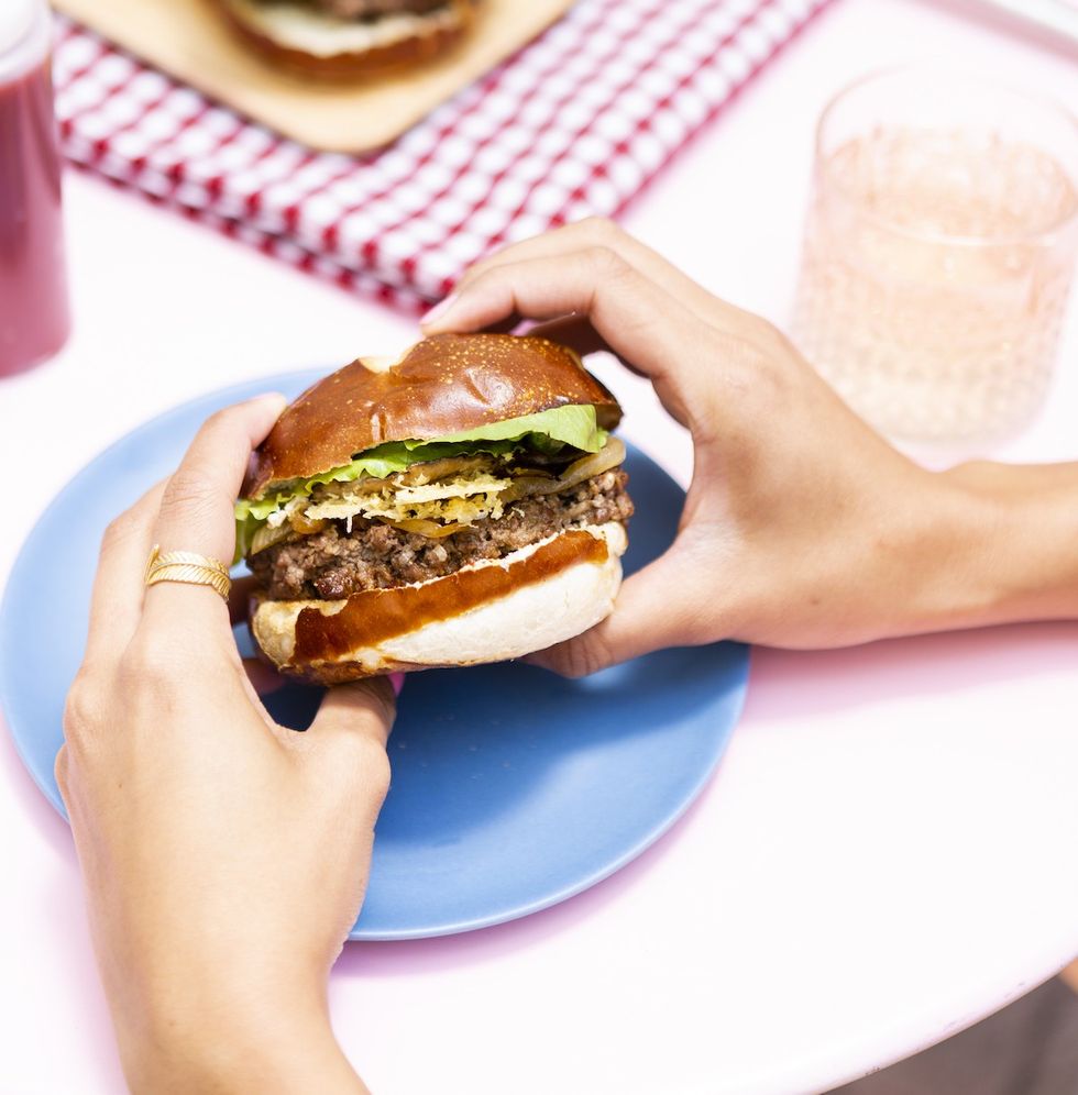 woman eating a cheeseburger