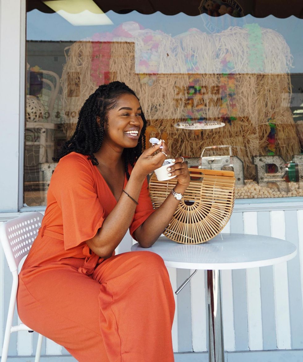 woman eating ice cream in orange outfit