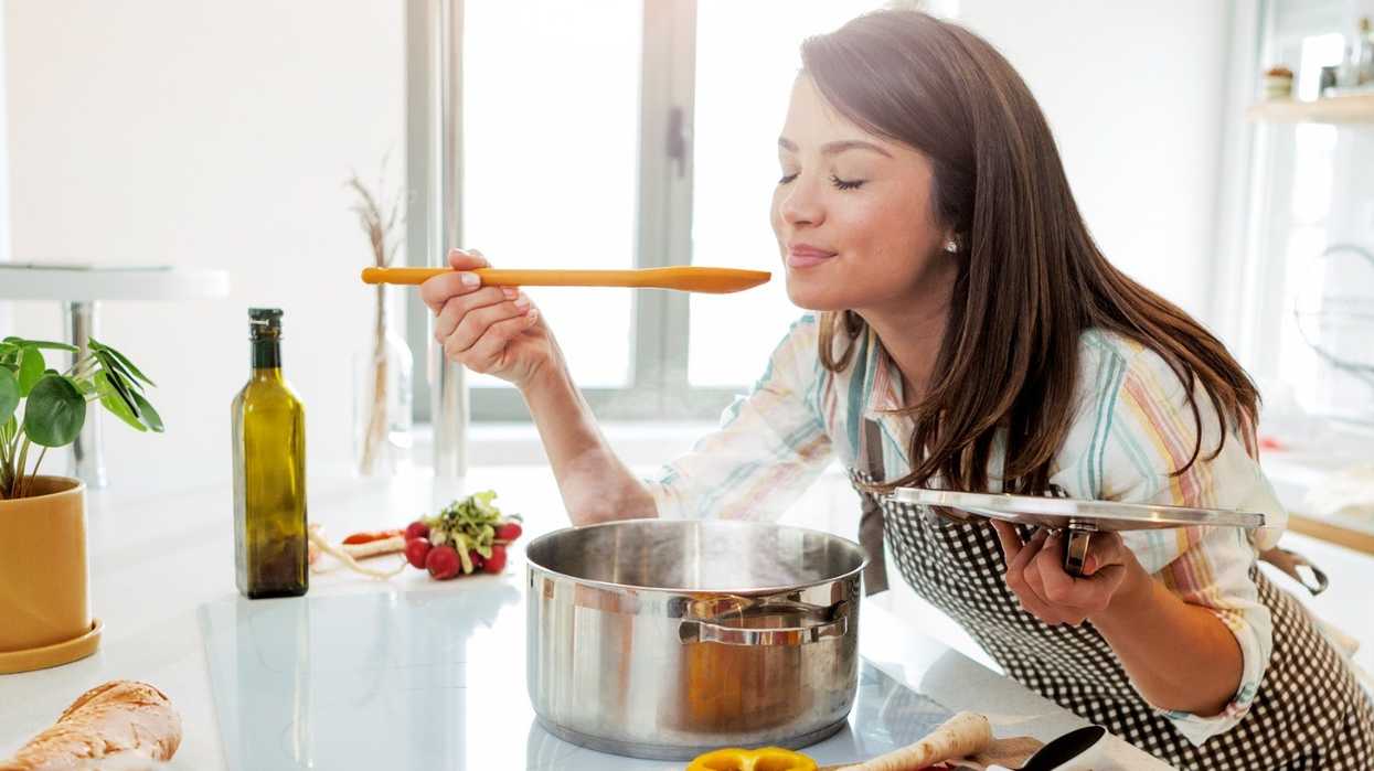 woman-enjoying-aroma-from-food-shes-cooking