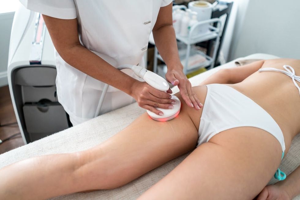 Woman getting a cellulite treatment at the spa. 