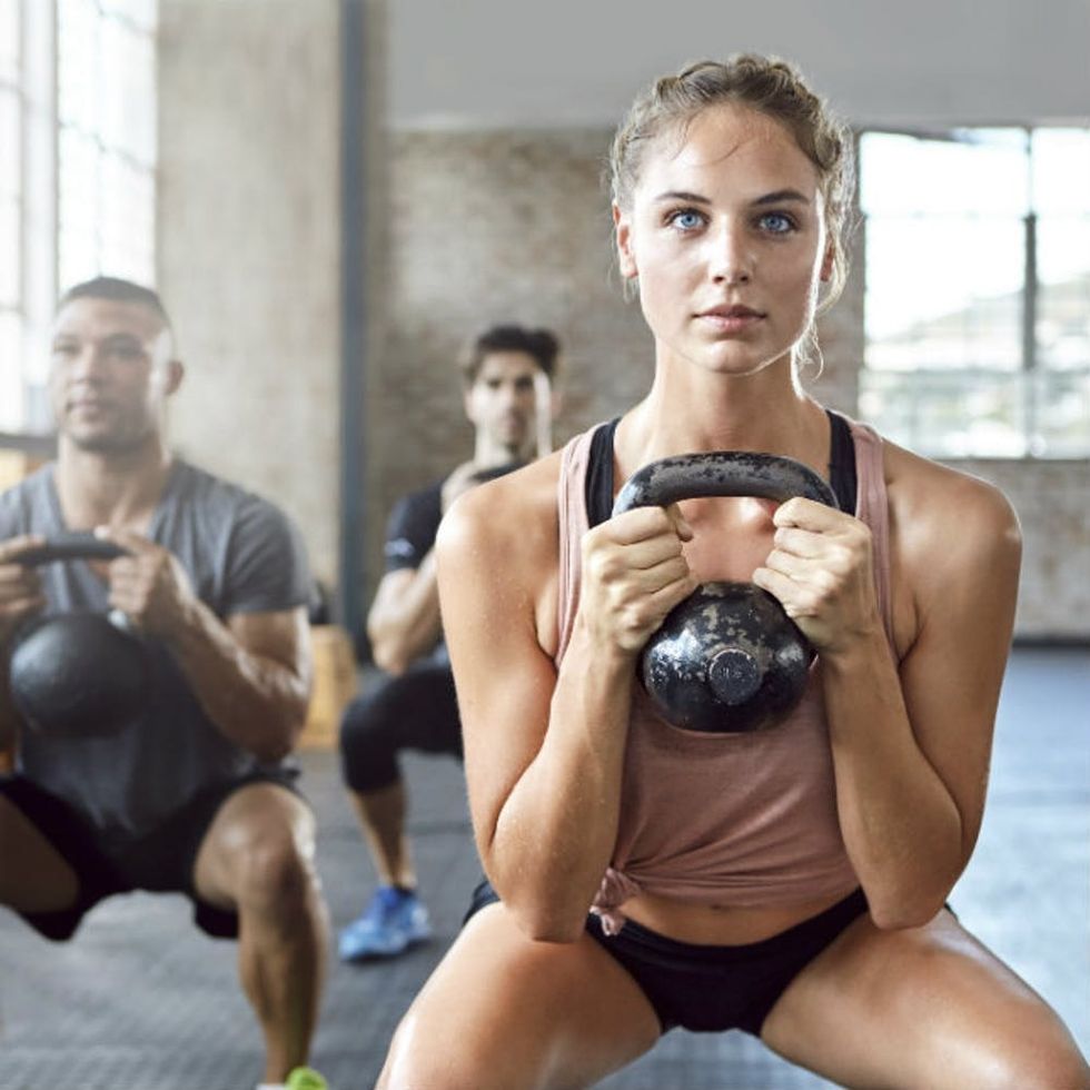 woman gym kettlebell exercise workout