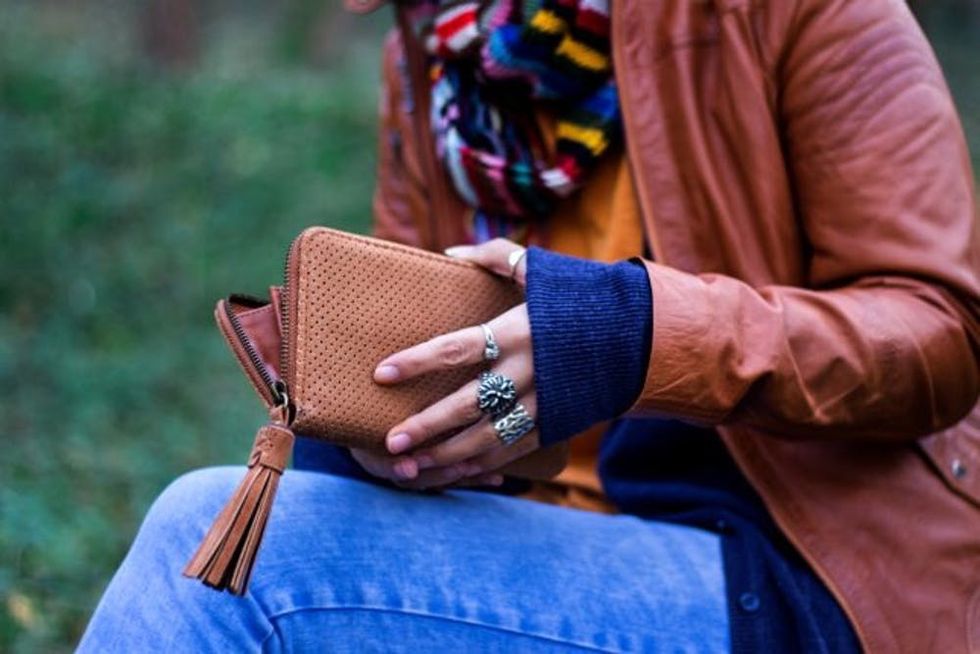 Woman hands holding empty wallet. Poverty, taxes, debts and other problems.