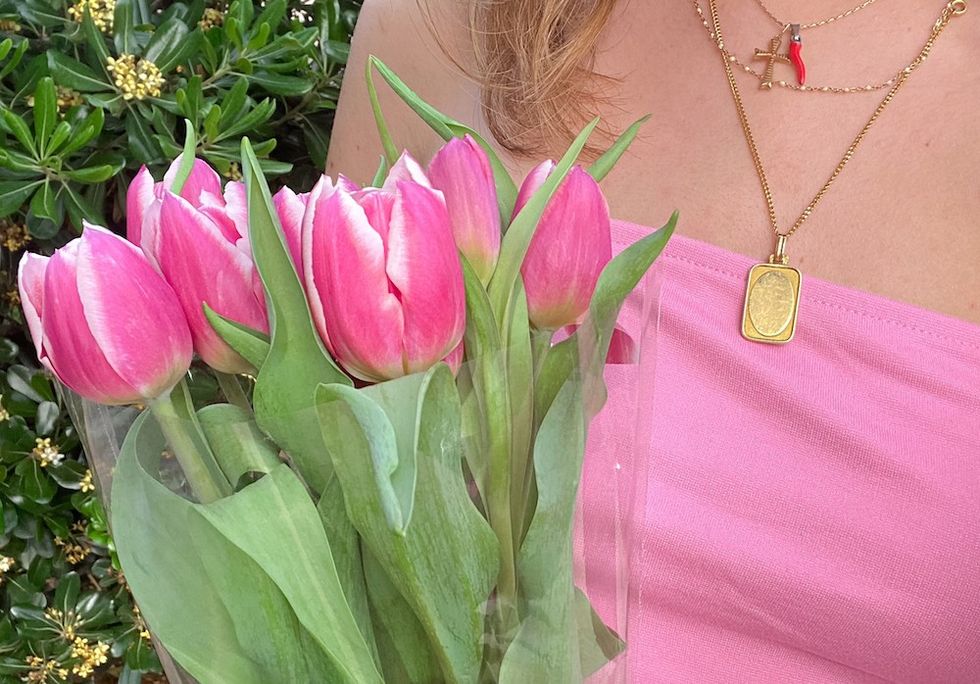 woman holding a bouquet of pink flowers