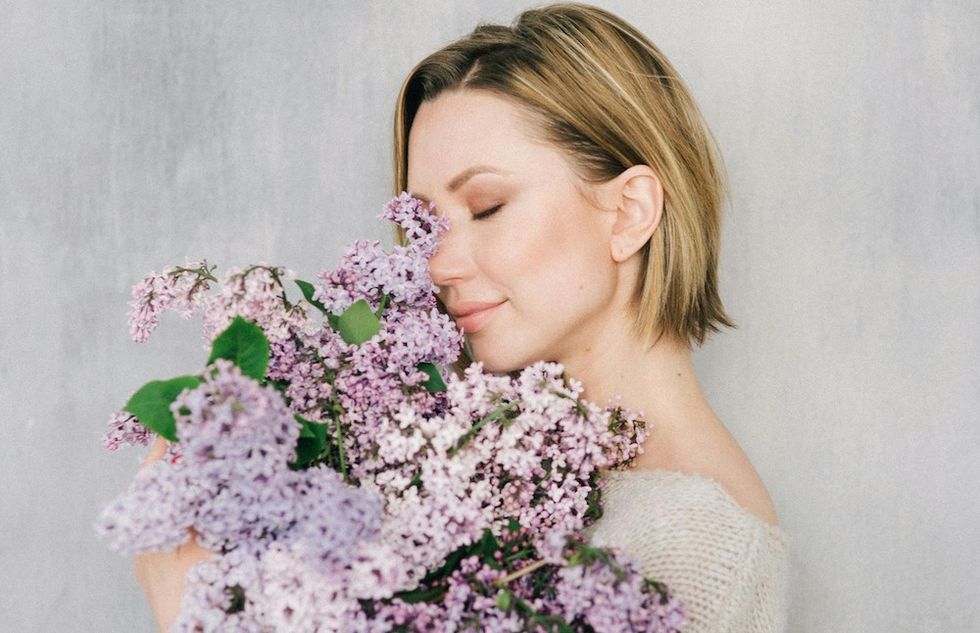 woman holding a bouquet of purple flowers