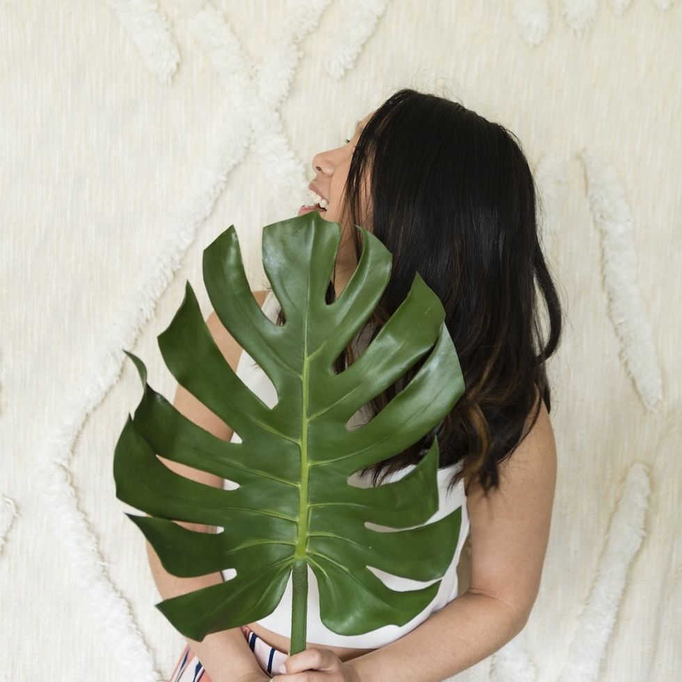woman holding a plant leaf