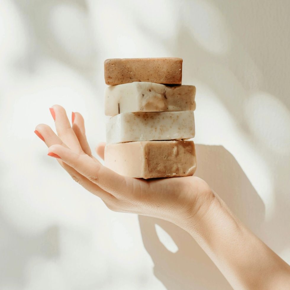 woman holding bar soap stacked in her hands
