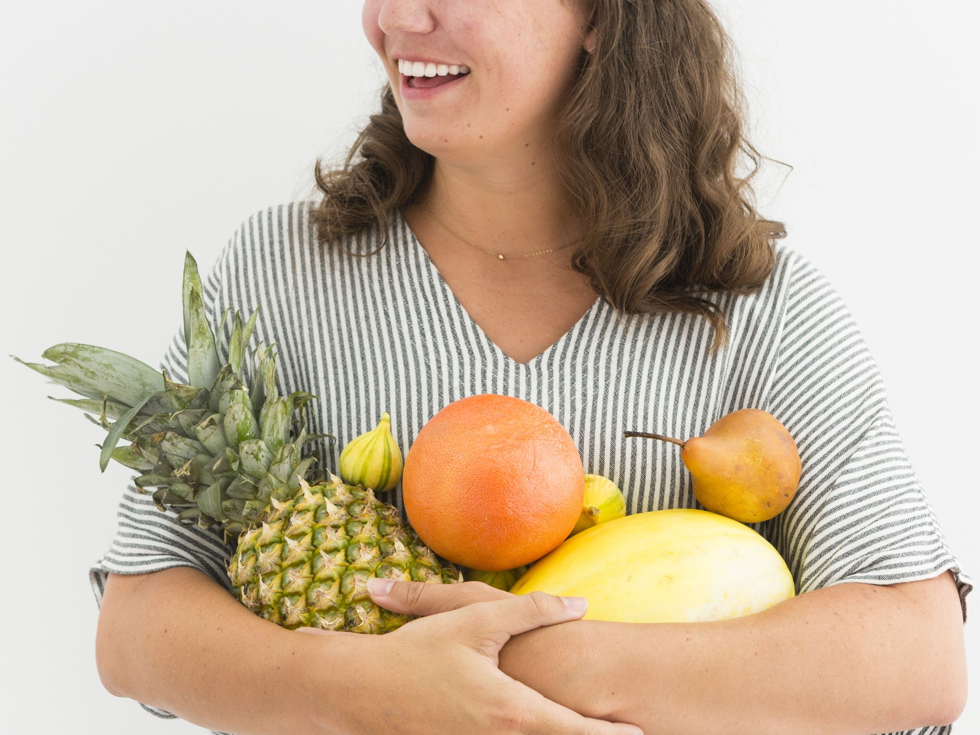 woman holding healthy fruits