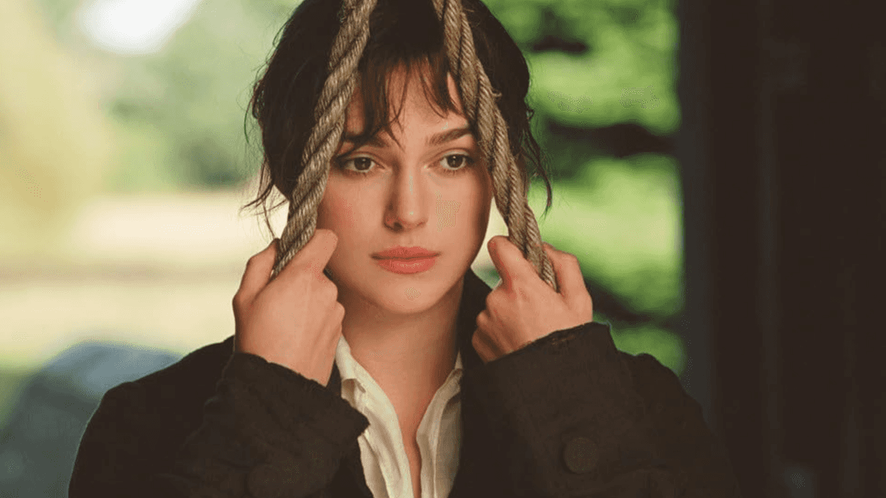 Woman holding ropes, gazing thoughtfully.
