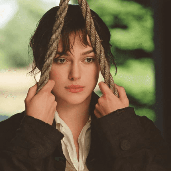 Woman holding ropes, gazing thoughtfully.
