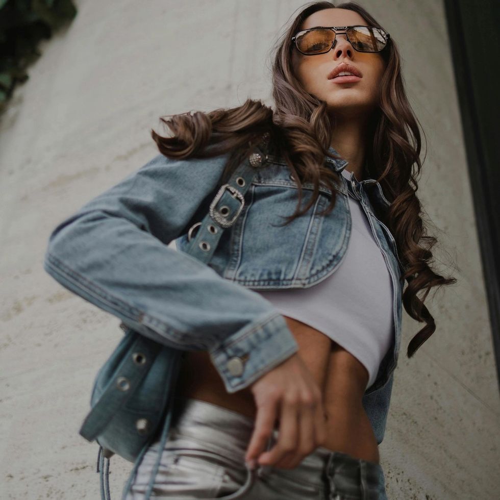 woman in a crop top and ultra low-rise jeans