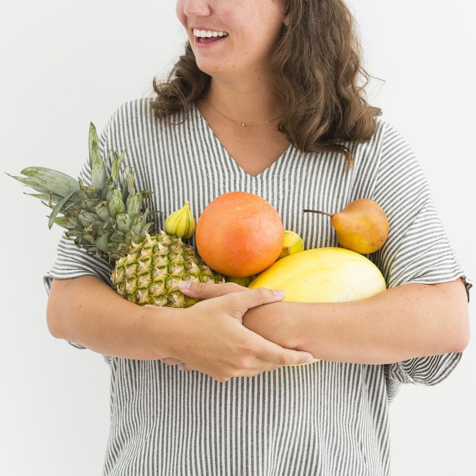 woman in a striped shirt holding fruit nutrition facts FAQ