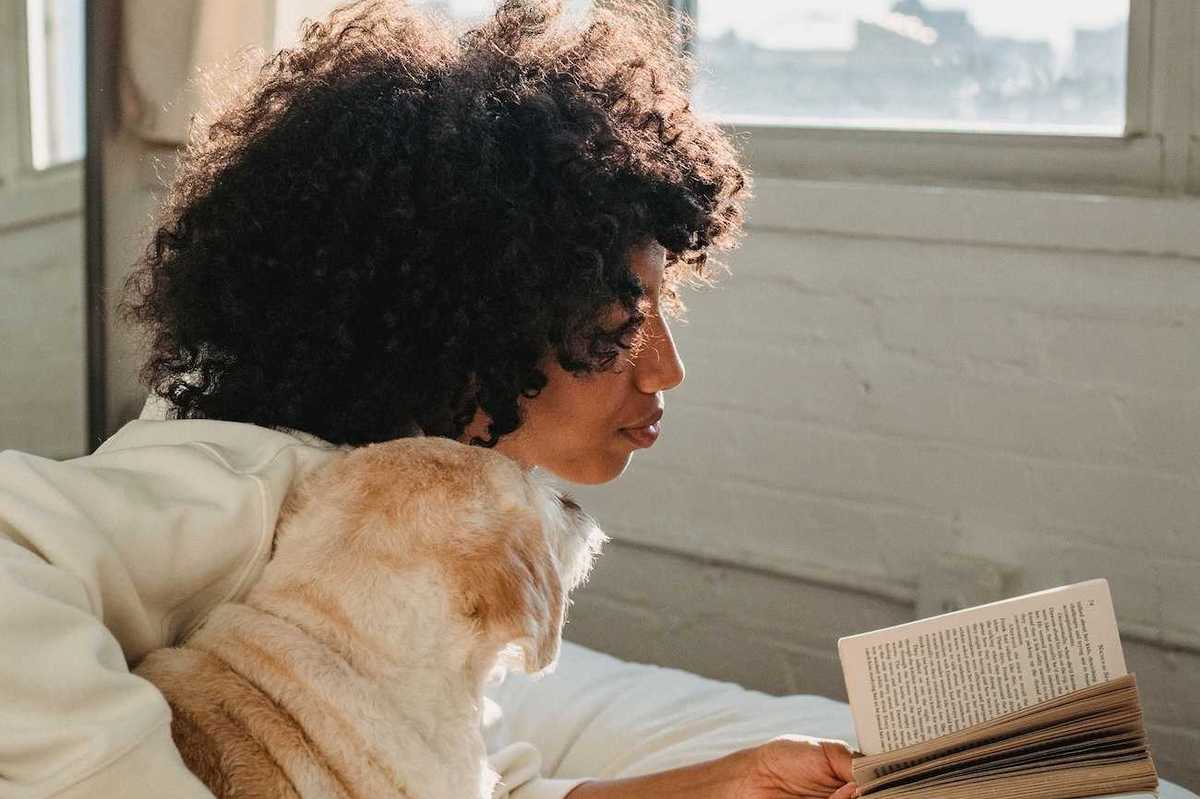 woman in bed reading a book tempest victoria aveyard
