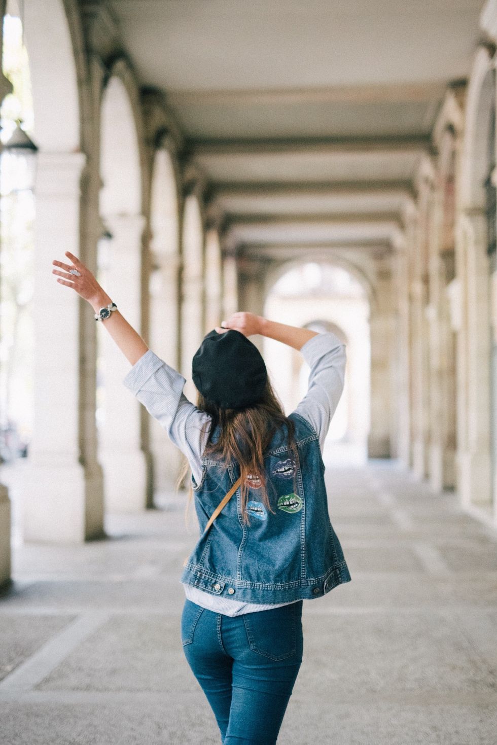 Woman in Blue Denim Jacket Standing on Gray Concrete Floor