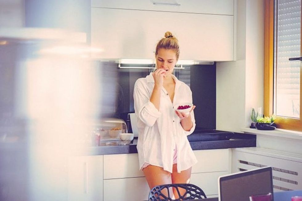 woman in kitchen having breakfast