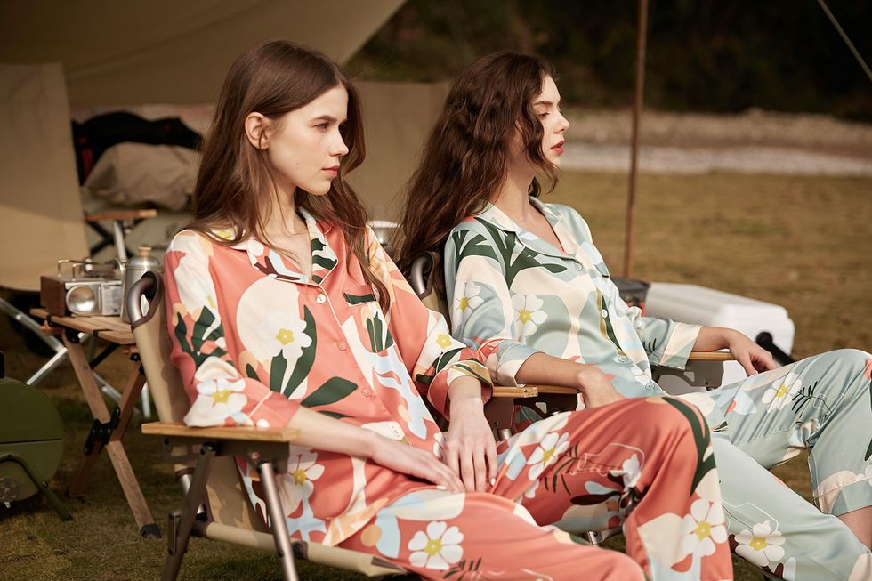 woman in pretty pajamas while camping birthday trip ideas