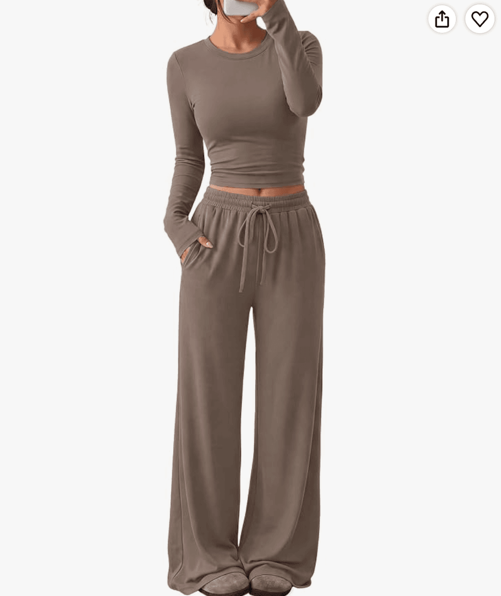 Woman in taupe loungewear set taking a mirror selfie.