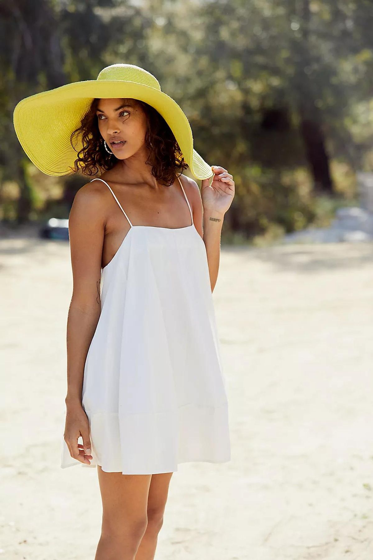 woman in yellow wide brim sun hat