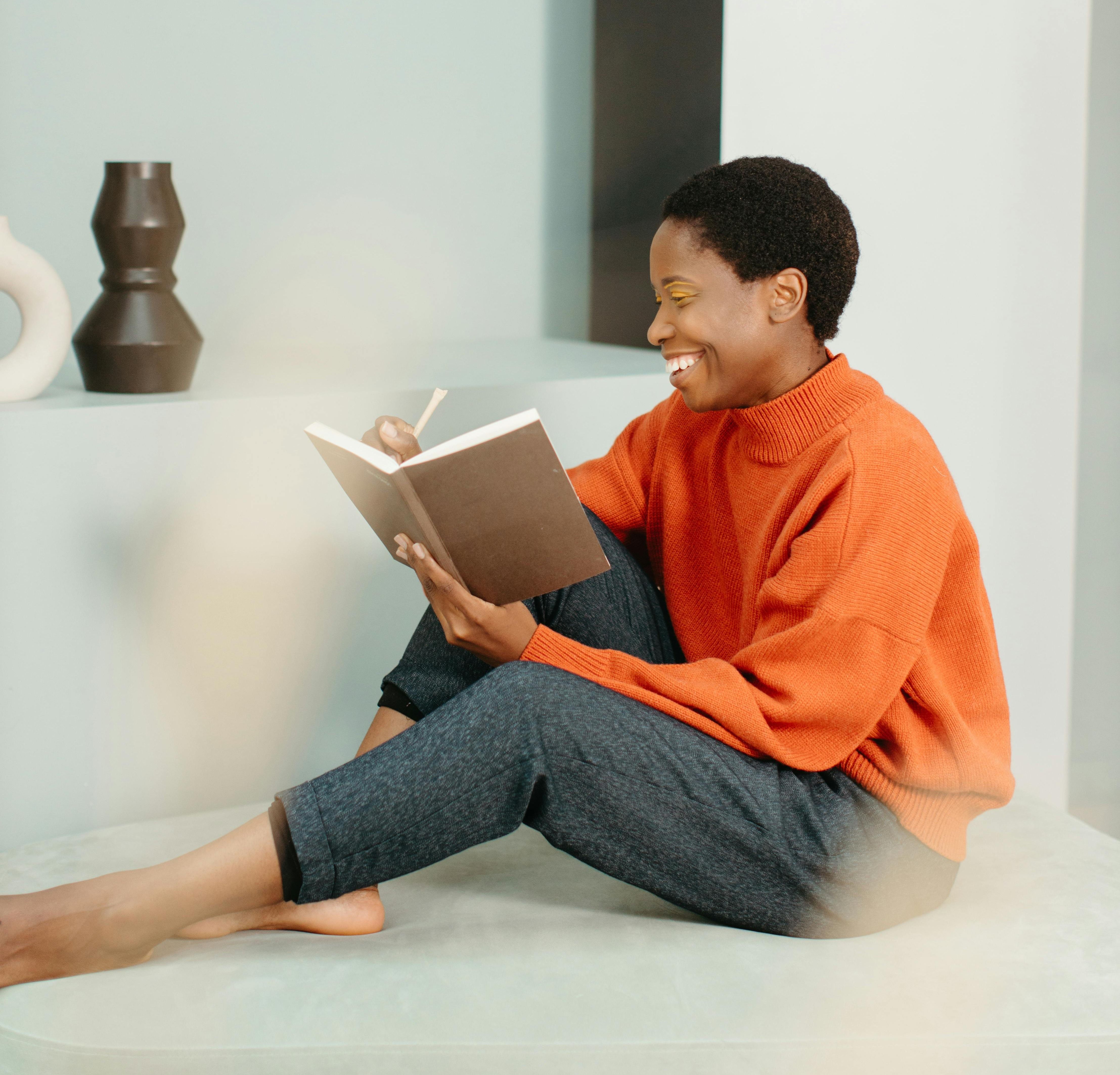 woman journaling on her couch