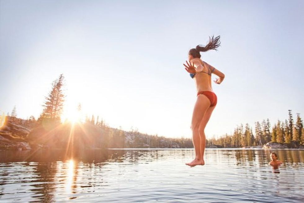 woman-jumping-lake