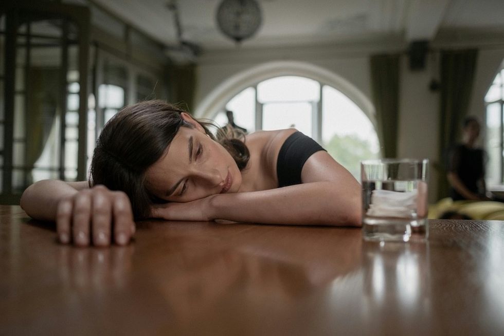 woman laying her head on the table