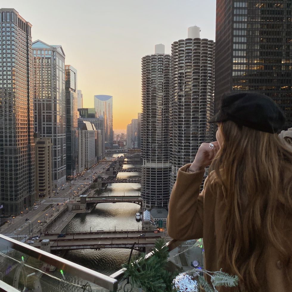 woman looking at the sunset in the city