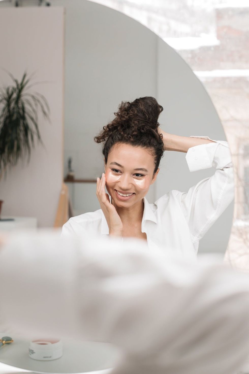 woman looking into the mirror Do dermatologists recommend ice rollers?