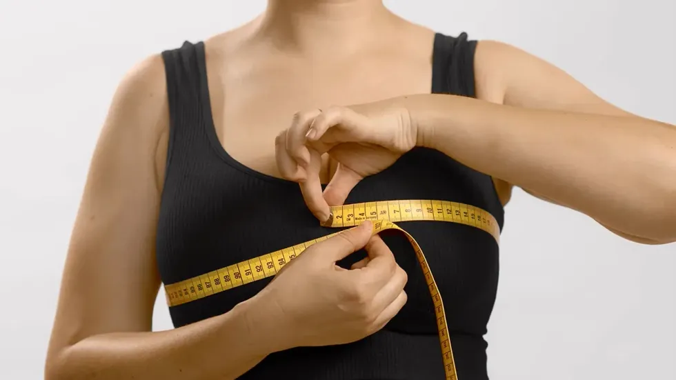 woman measuring for her bra size
