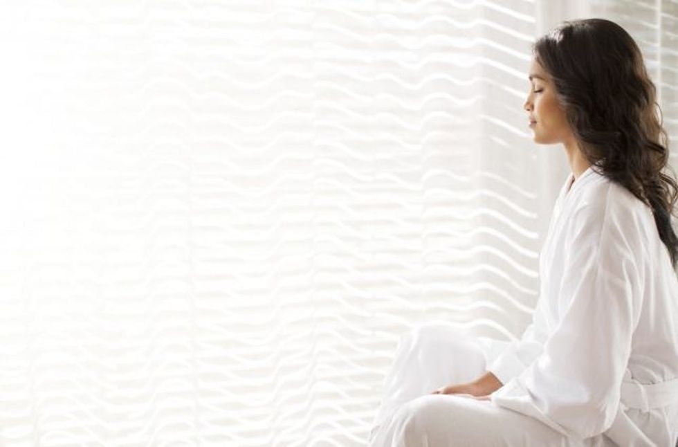 woman meditating at home