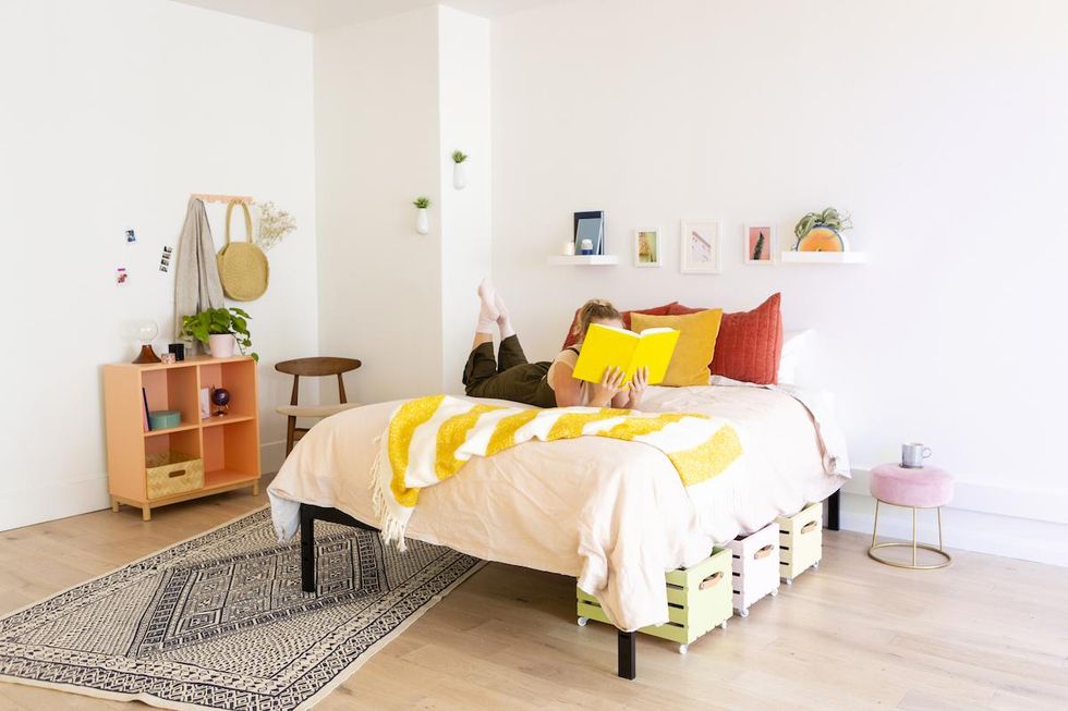 woman on her bed with book