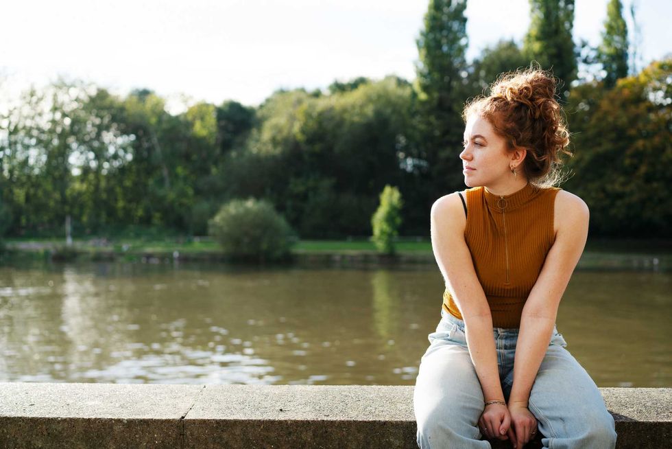 woman pensive by water