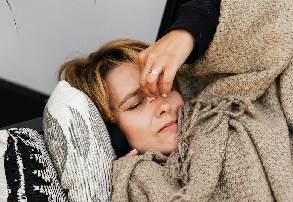 woman pinching the bridge of her nose