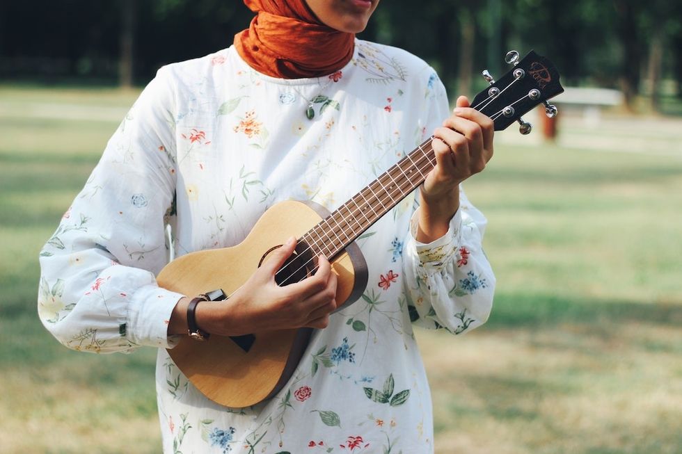 woman playing the ukulele what to do after a breakup