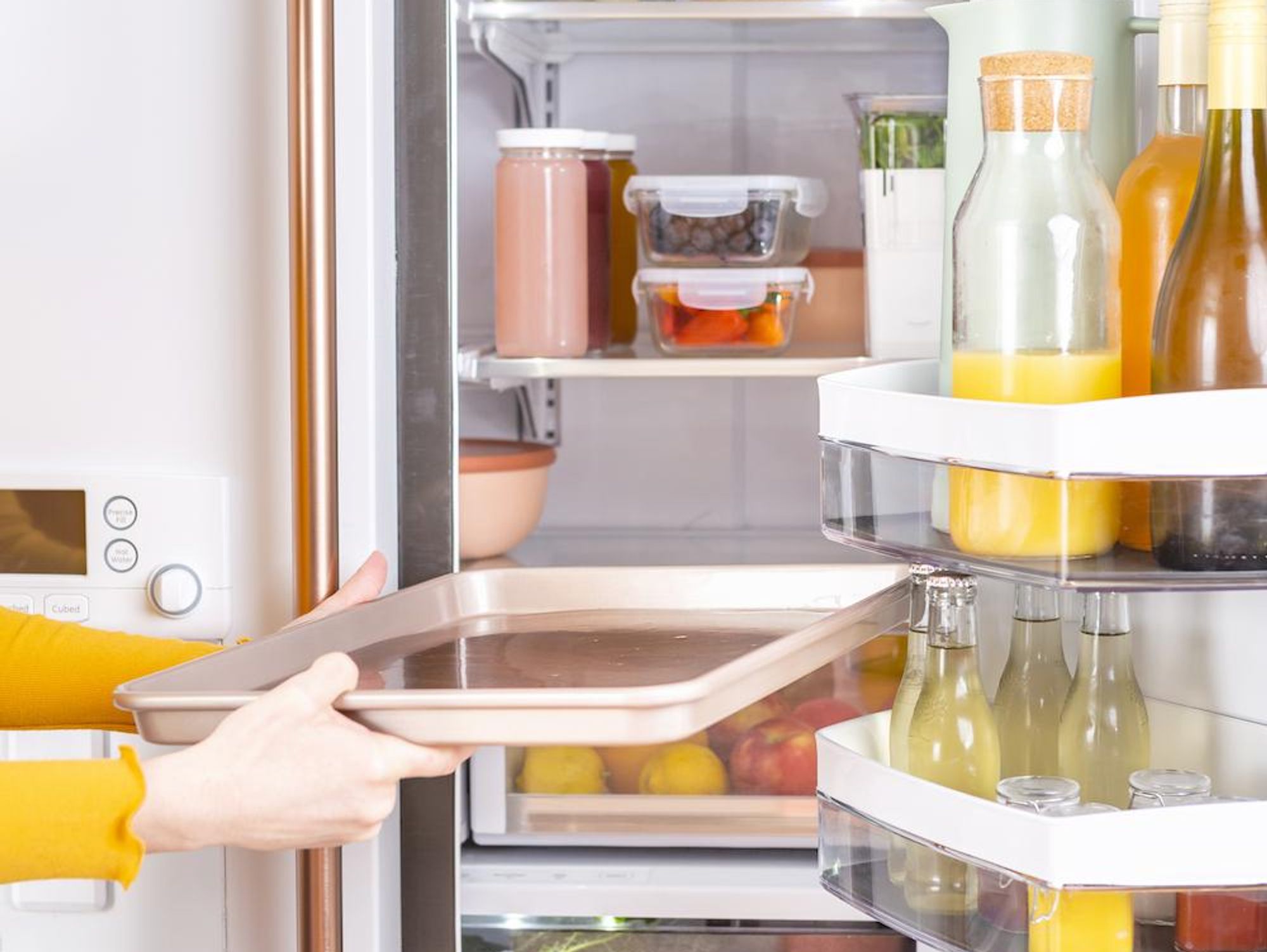 woman putting a baking sheet in her fridge change your address