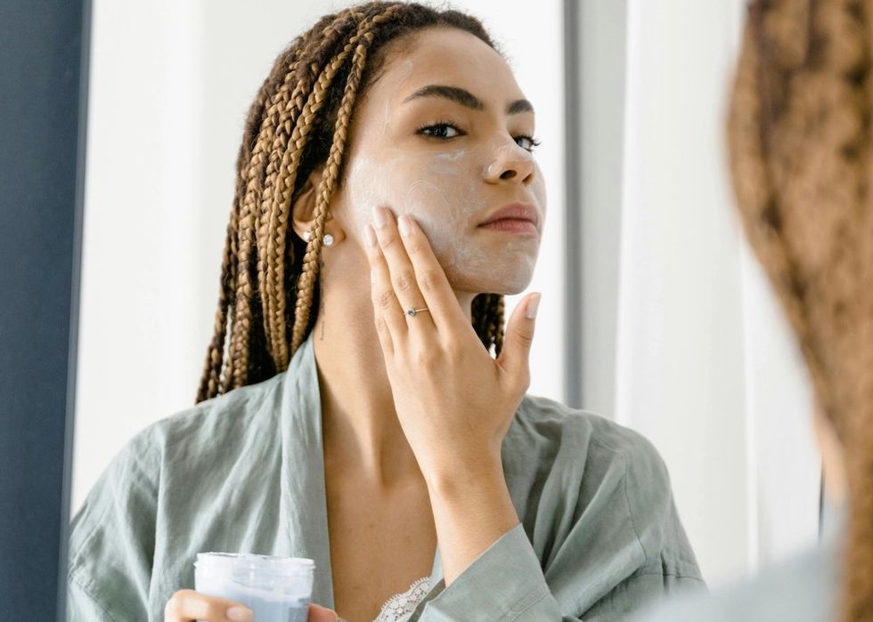 woman putting on a face mask