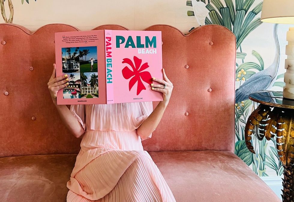 woman reading a book about palm beach