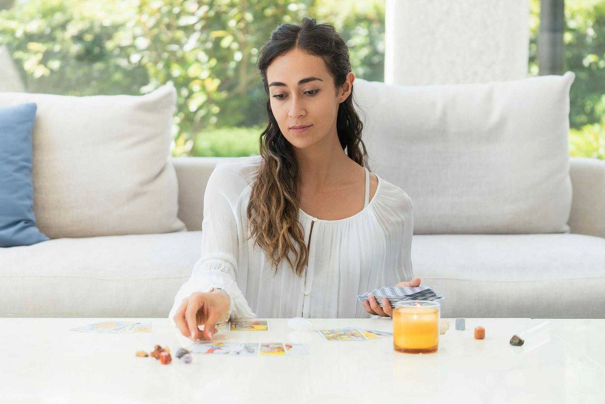 woman reading tarot cards - star tarot card meaning 