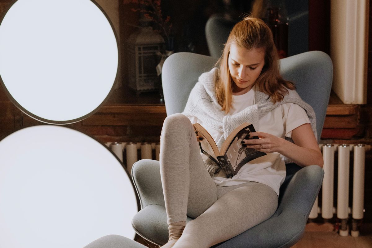 woman reading with lights on