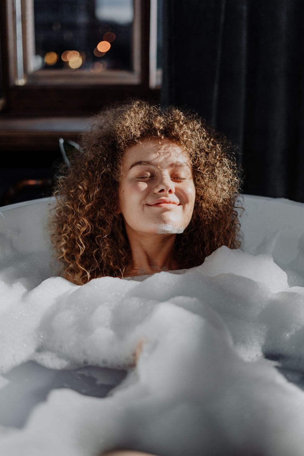 woman relaxing in bubble bath