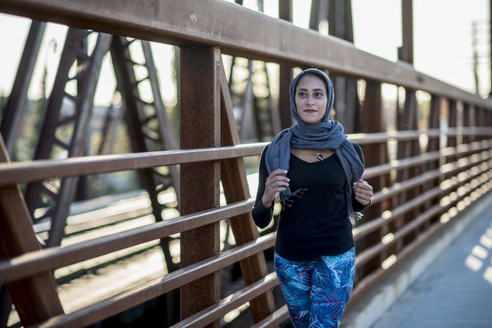 Woman running on a bridge