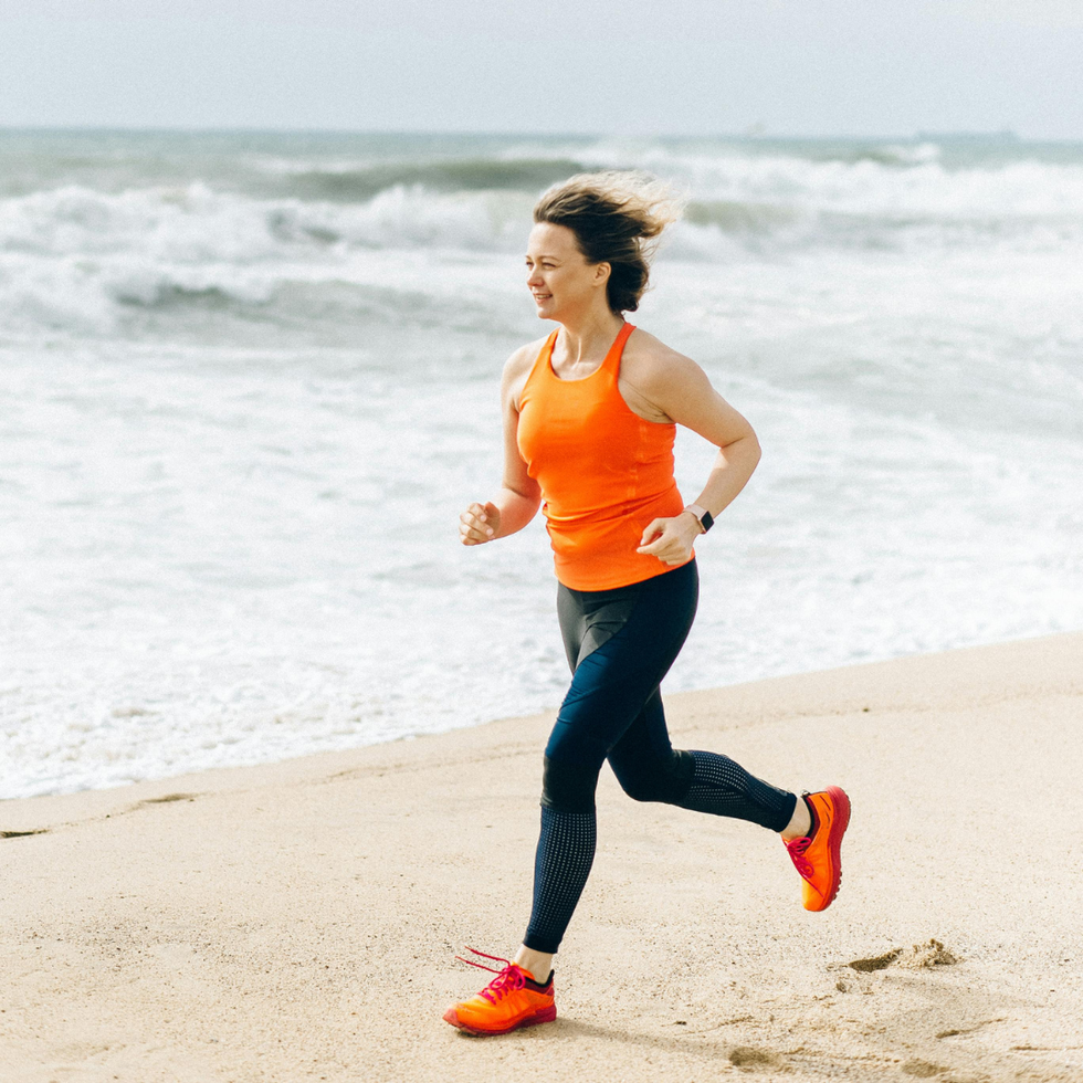 Woman Running On Beach