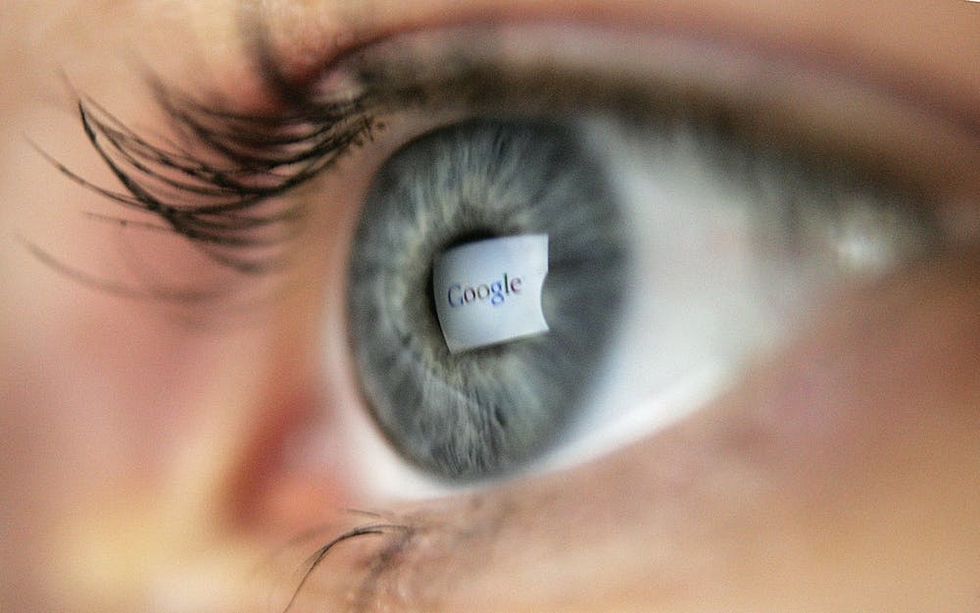 Woman's eye reflecting the Google logo as she browses the web.