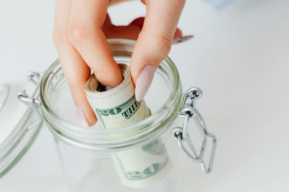 woman saving money in a jar