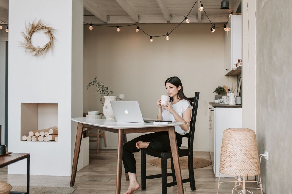 woman sipping tea at her desk